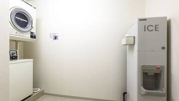 A laundry room with a washing machine, a dryer, and an ice dispenser.