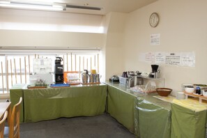 A room with a green-covered buffet table, a clock on the wall, and a window with blinds. - Wakayama Daiichi Fuji Hotel (Wakayama)