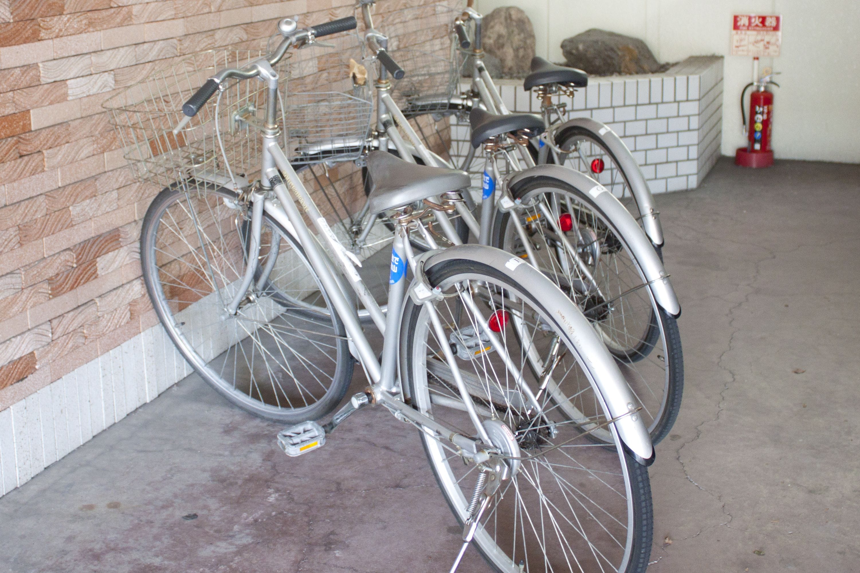 Bicycles parked against a wall in a garage.