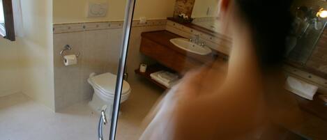 A bathroom with a toilet, sink, and shower.
