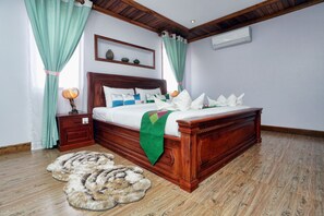 Un dormitorio con una cama de madera, una mesita de noche, una lámpara y un tapete decorativo.