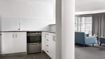 One Bedroom Executive Apartment | Private kitchen | Full-size fridge, microwave, oven, stovetop