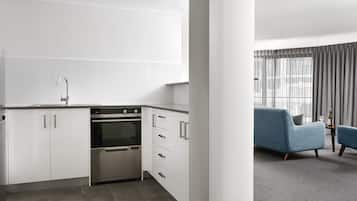 One Bedroom Executive Apartment | Private kitchen | Full-sized fridge, microwave, oven, stovetop