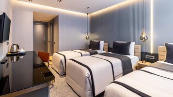 Triple Room | Minibar, in-room safe, desk, soundproofing