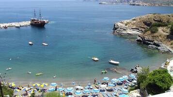 On the beach, sun loungers, beach umbrellas, beach bar