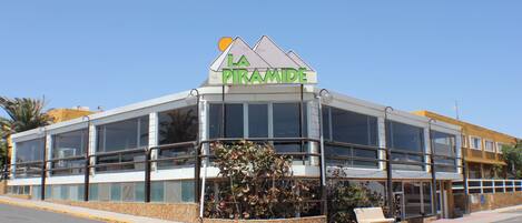 A modern building with a sign reading "LA Pyramide".