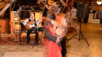 A dance floor with a band performing in the background.