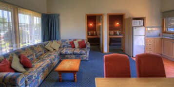 Deluxe Suite (Family) | Living room | 32-cm flat-screen TV with digital channels, TV, DVD player