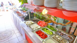 A buffet with various food items and a glass display case. - Zinbad Hotel (Kas)