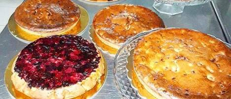 A variety of pies on a stainless steel counter.