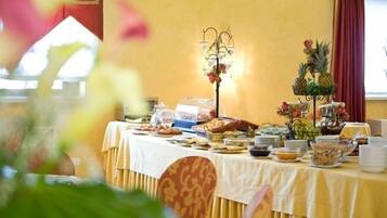 A buffet table with various food items and a decorative centerpiece.