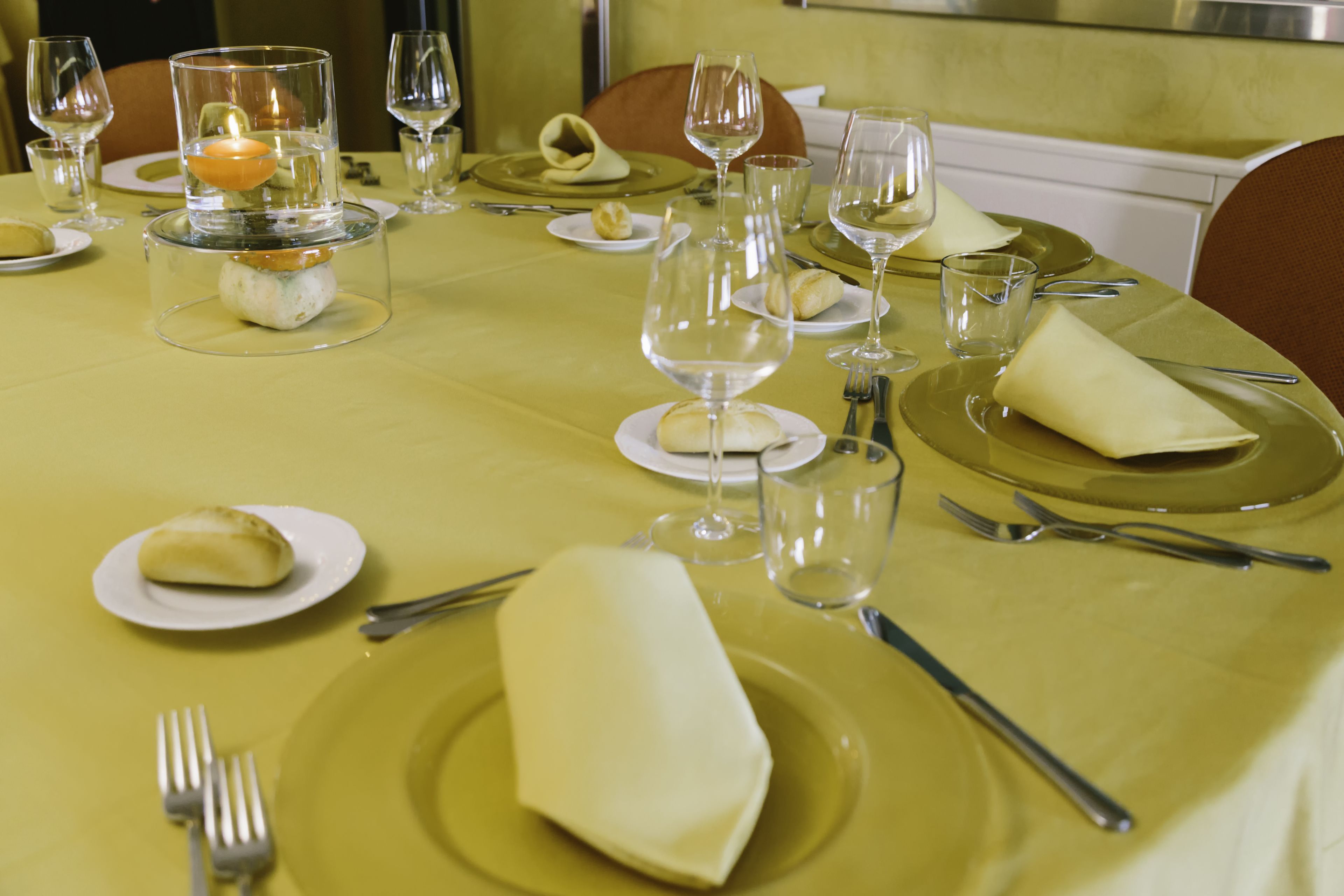 A table set for a meal with plates, glasses, and cutlery.