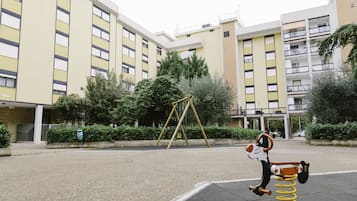 Children can play on the swing set and spring-mounted toy in the adjacent playground.