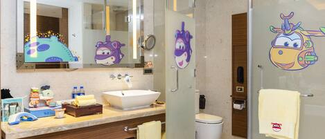 A modern bathroom with a large mirror, a white sink, a bathtub, and a toilet.