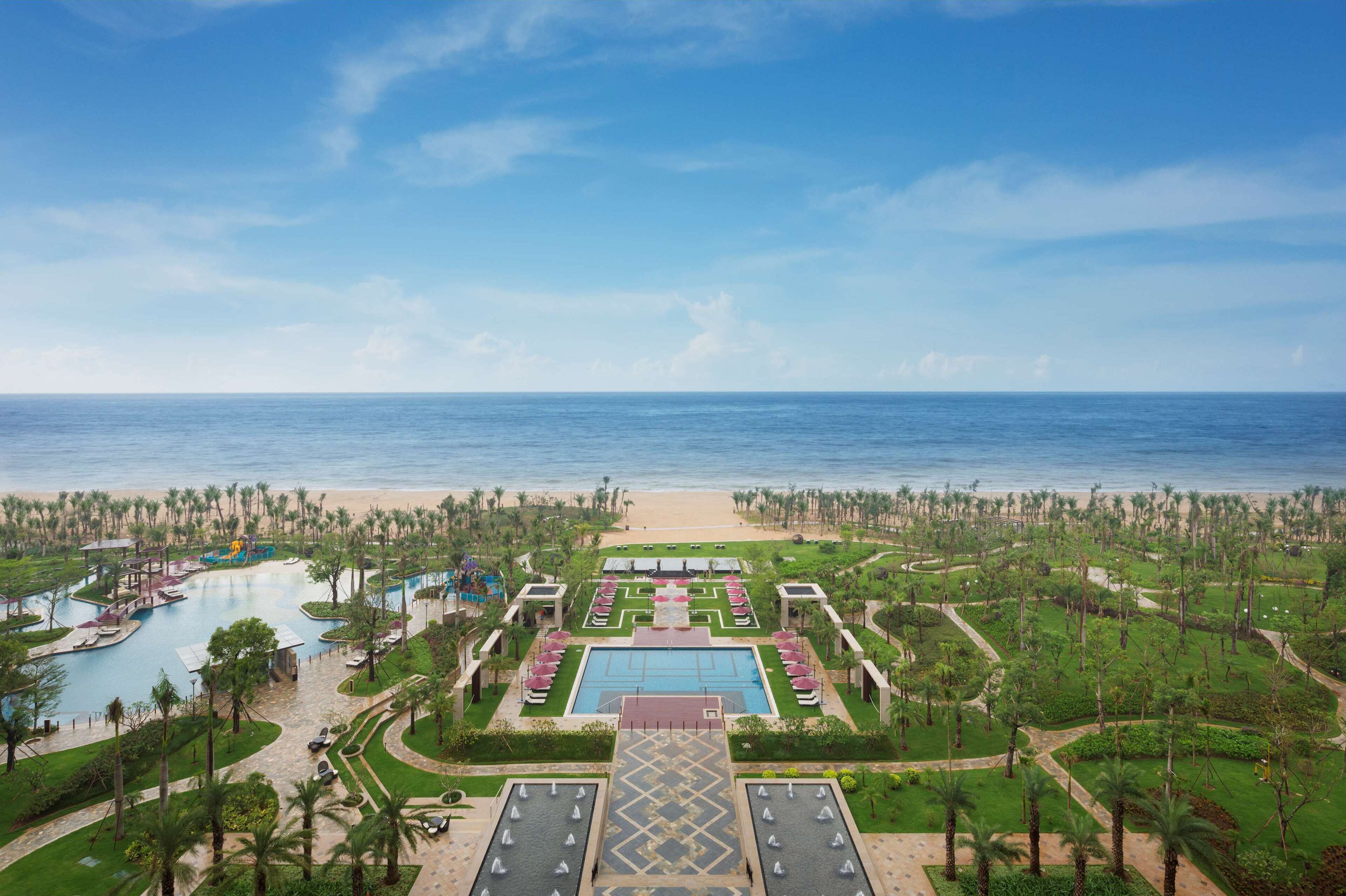 A resort with a central pool, multiple smaller pools, and a beach area.