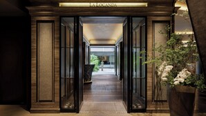 A hallway with a sign reading "LA LOCANDA" leading to a well-lit interior space. - The Ritz-Carlton, Kyoto (Kyoto)