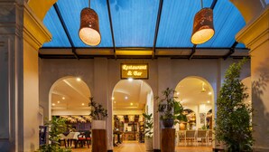 A restaurant & bar with a covered entrance, potted plants, and a tiled floor. - La Residence WatBo Hotel (Siem Reap)