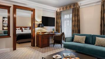 Ein Hotelzimmer mit einem Bett, einem Schreibtisch, einem Fernseher, einem Sofa und einem Couchtisch.
