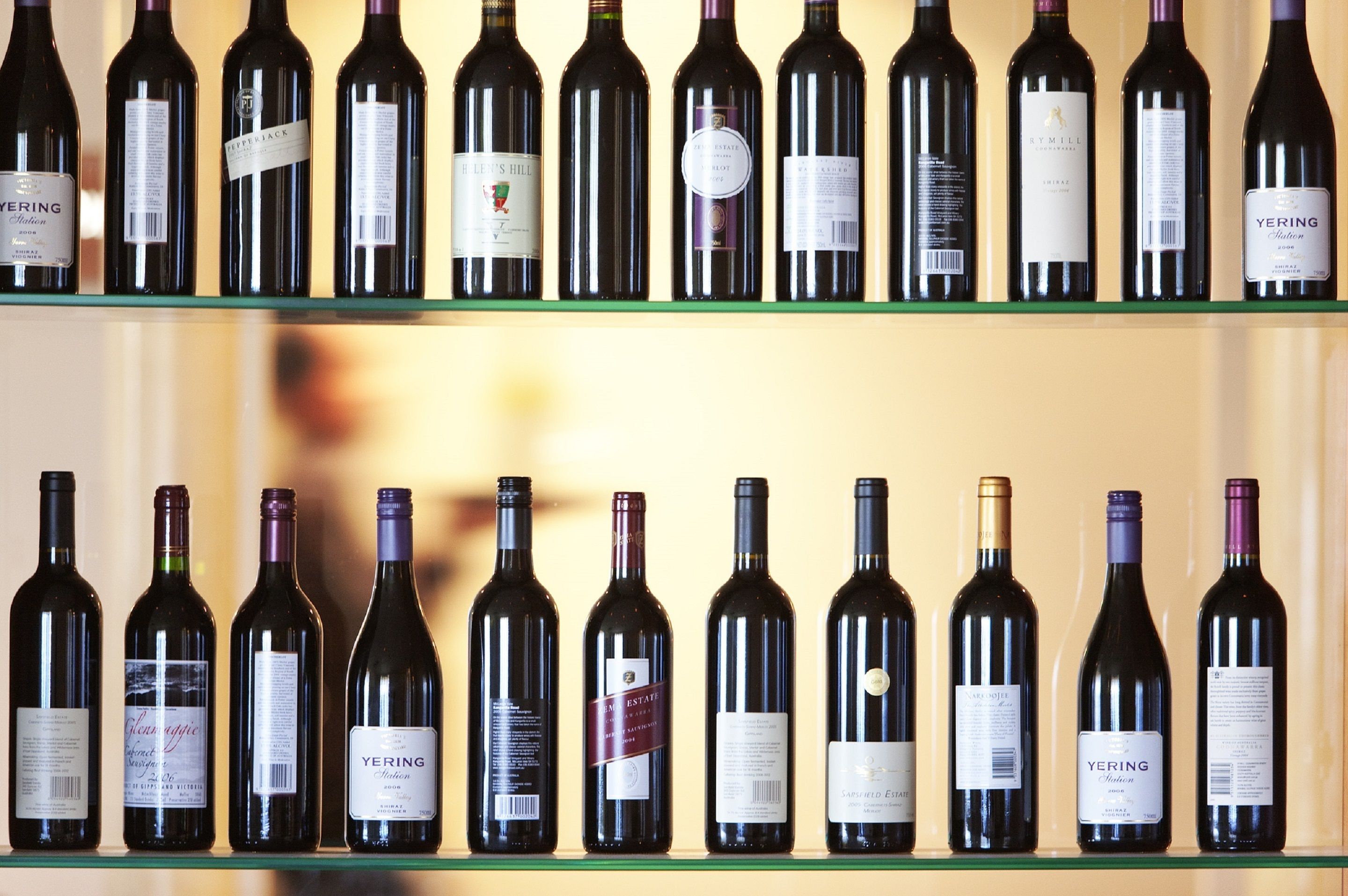 A row of wine bottles on shelves.