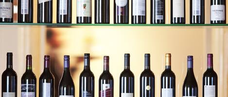 A row of wine bottles on shelves.