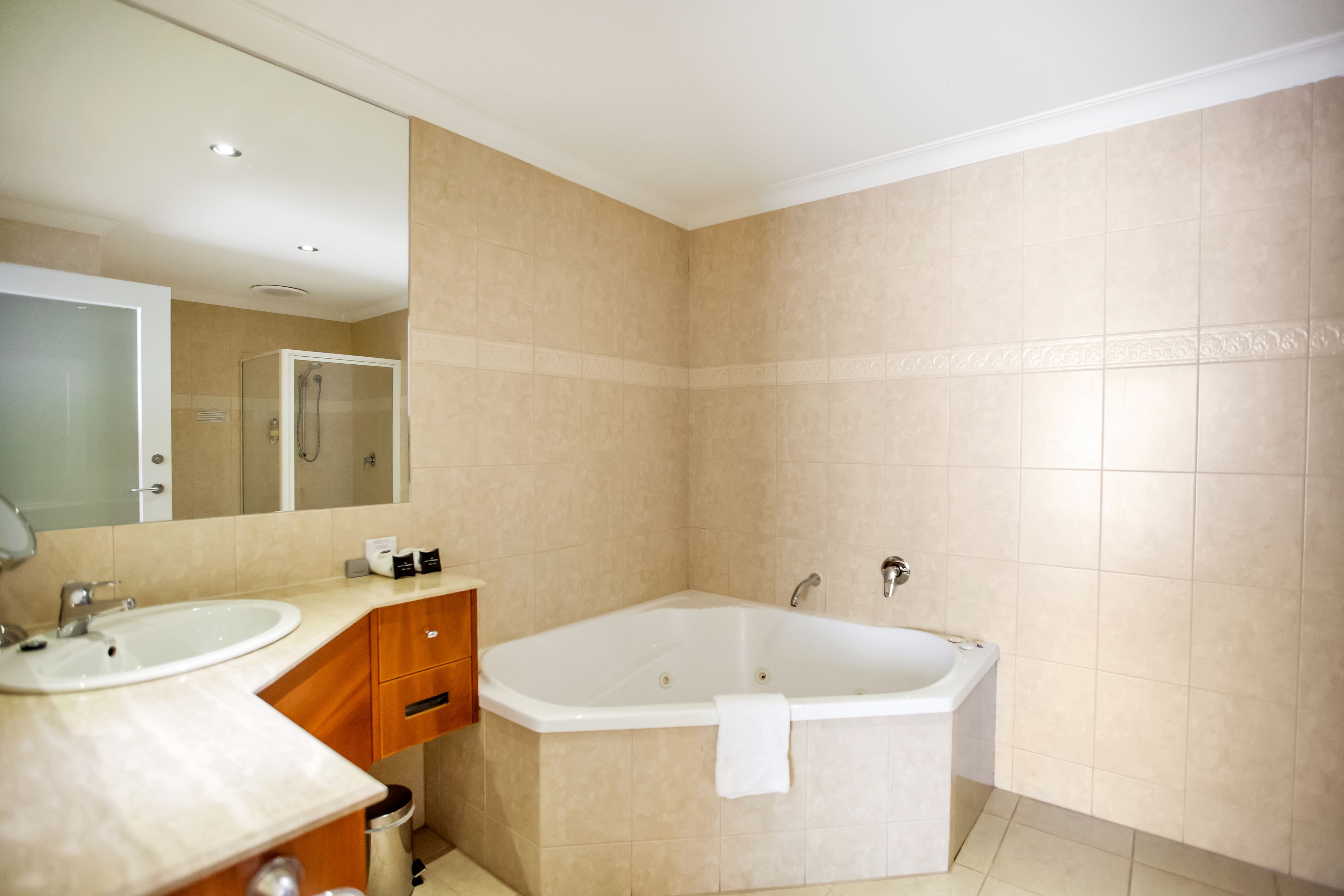 A modern bathroom with a bathtub, a sink, and a vanity.