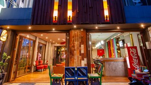 A modern building with a wooden facade and colorful vertical accents. - Madam Inn Patong (Patong)