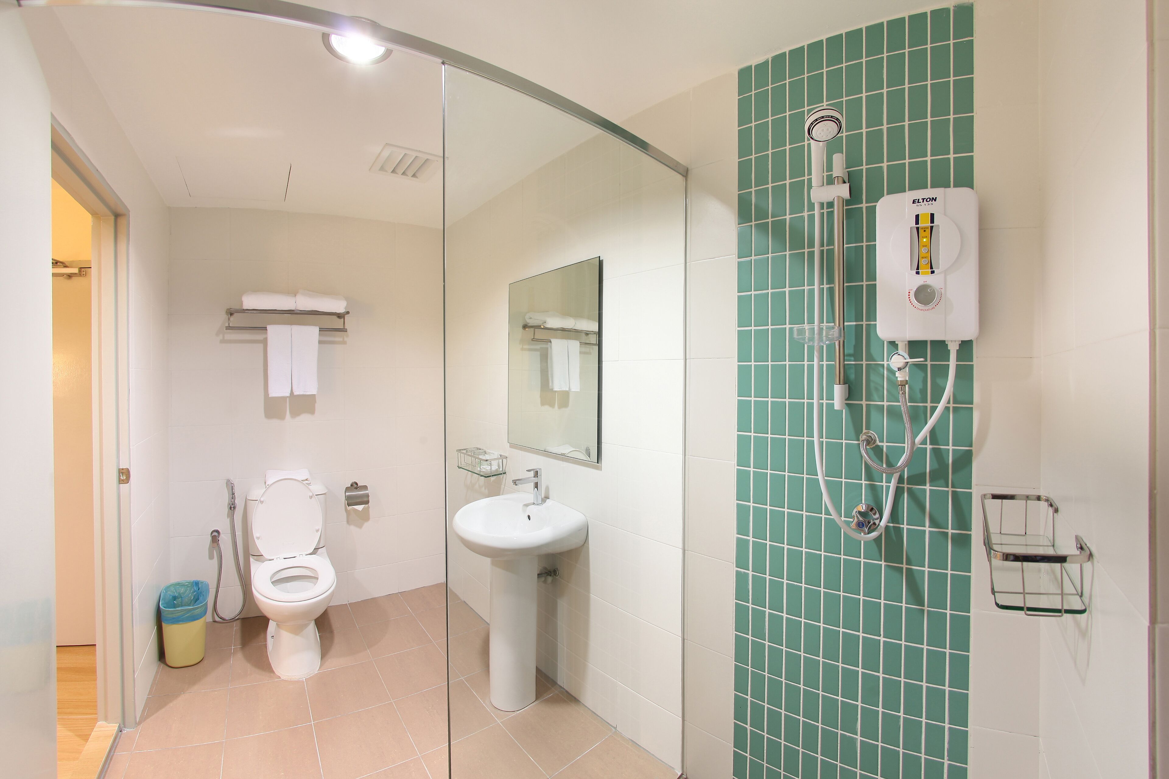 Un baño con inodoro, lavamanos y ducha.
