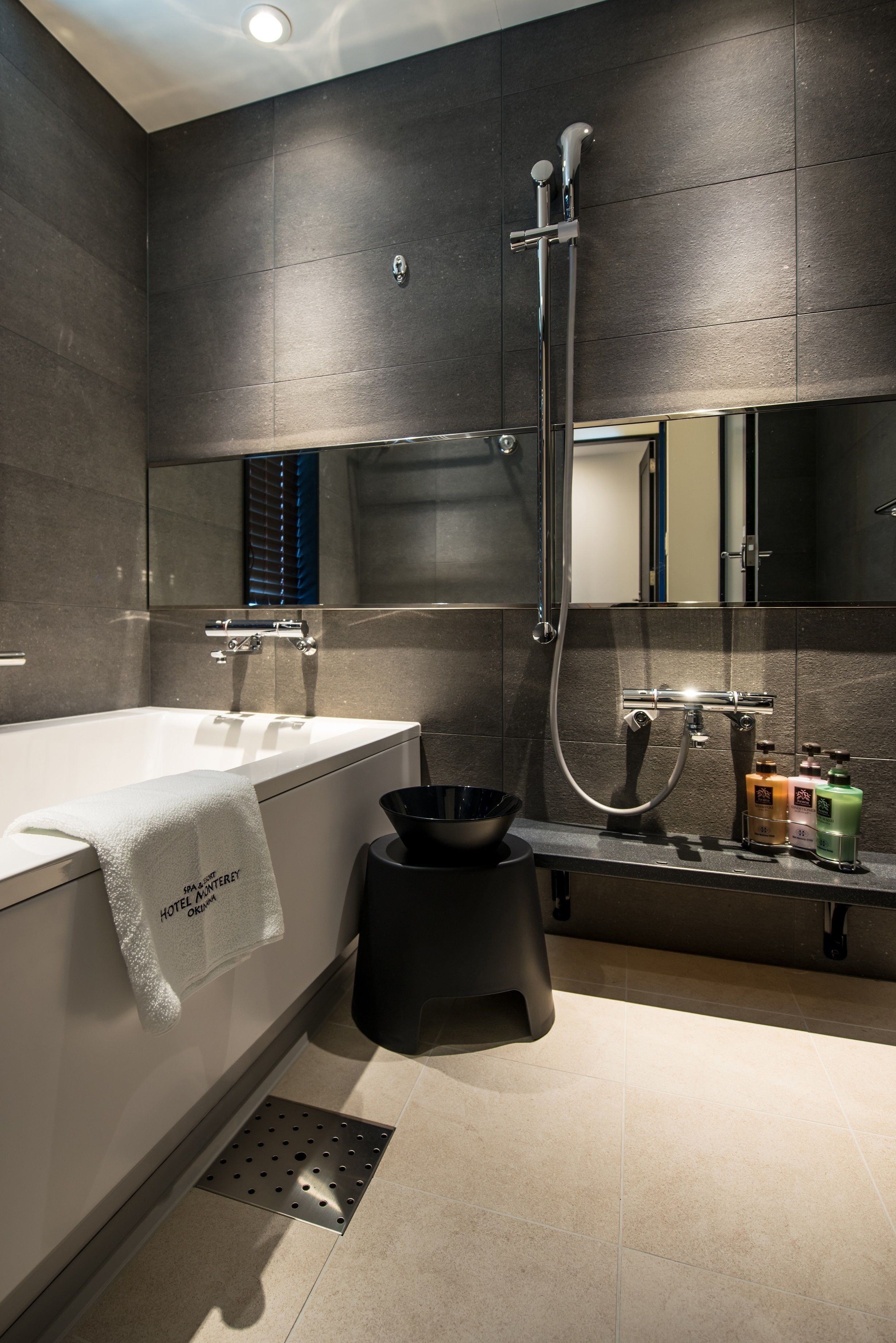A modern bathroom with a bathtub, a shower, and a toilet.