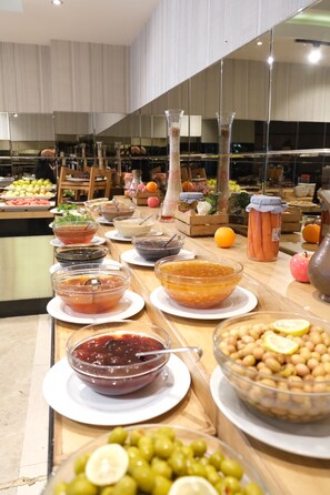A buffet table with various food items and condiments. - Asia City Hotel Istanbul (Istanbul)