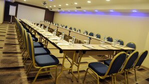 A conference room with long tables, chairs, water bottles, and a projector screen. - Asia City Hotel Istanbul (Istanbul)