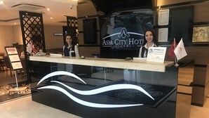 A reception desk at Asia City Hotel in Istanbul with a modern design, including a black and white wave pattern on the floor. - Asia City Hotel Istanbul (Istanbul)