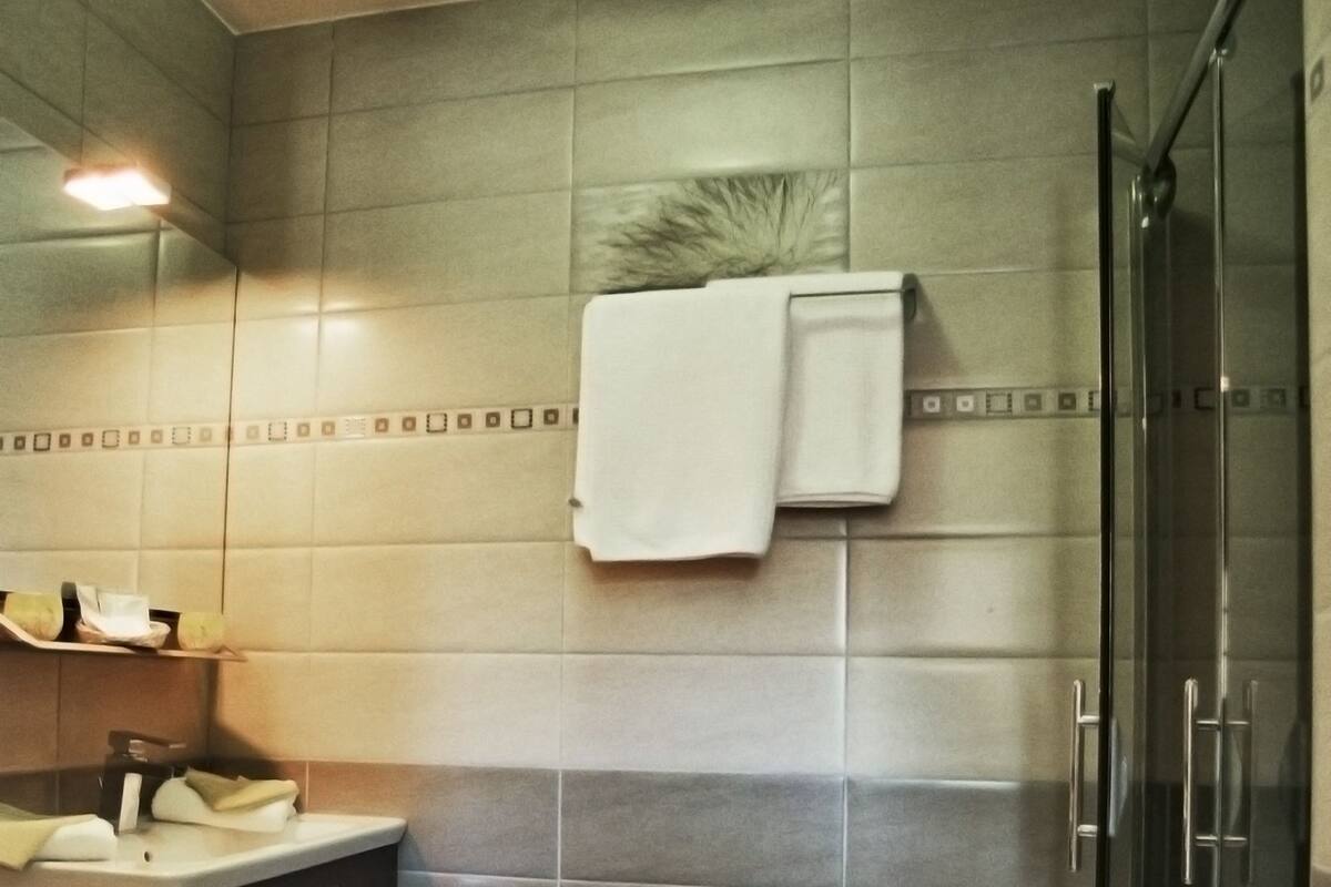 A modern bathroom with a toilet, sink, and shower area.