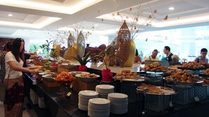 A buffet with various food items and decorative elements. - Sokhalay Angkor Inn (Siem Reap)
