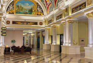 A grand lobby with ornate columns, a checkered floor, and a large mural on the ceiling. - Country Garden Phoenix Hotel (Wuhu)