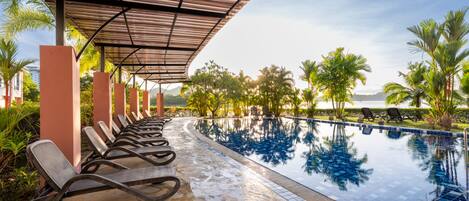 A poolside area with lounge chairs and a clear view of the pool.