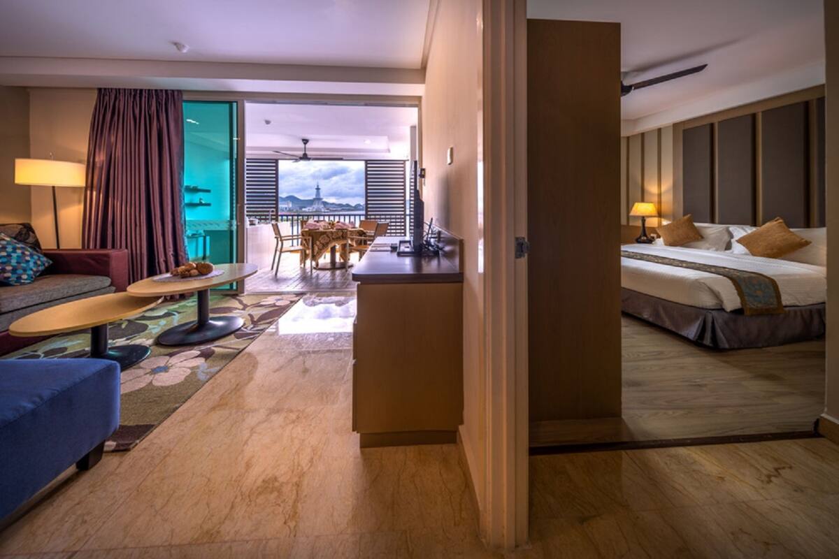 Une chambre d’hôtel comprenant un lit, un bureau, un canapé et un coin repas avec vue sur le paysage urbain.