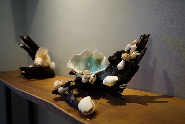 Ein Holzboden mit dekorativen Muscheln und Treibholz.