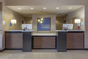 A hotel reception area with two HP computer stations, a Holiday Inn Express sign, and a no-smoking sign. - Holiday Inn Express & Suites Indio - Coachella Valley by IHG (Indio)
