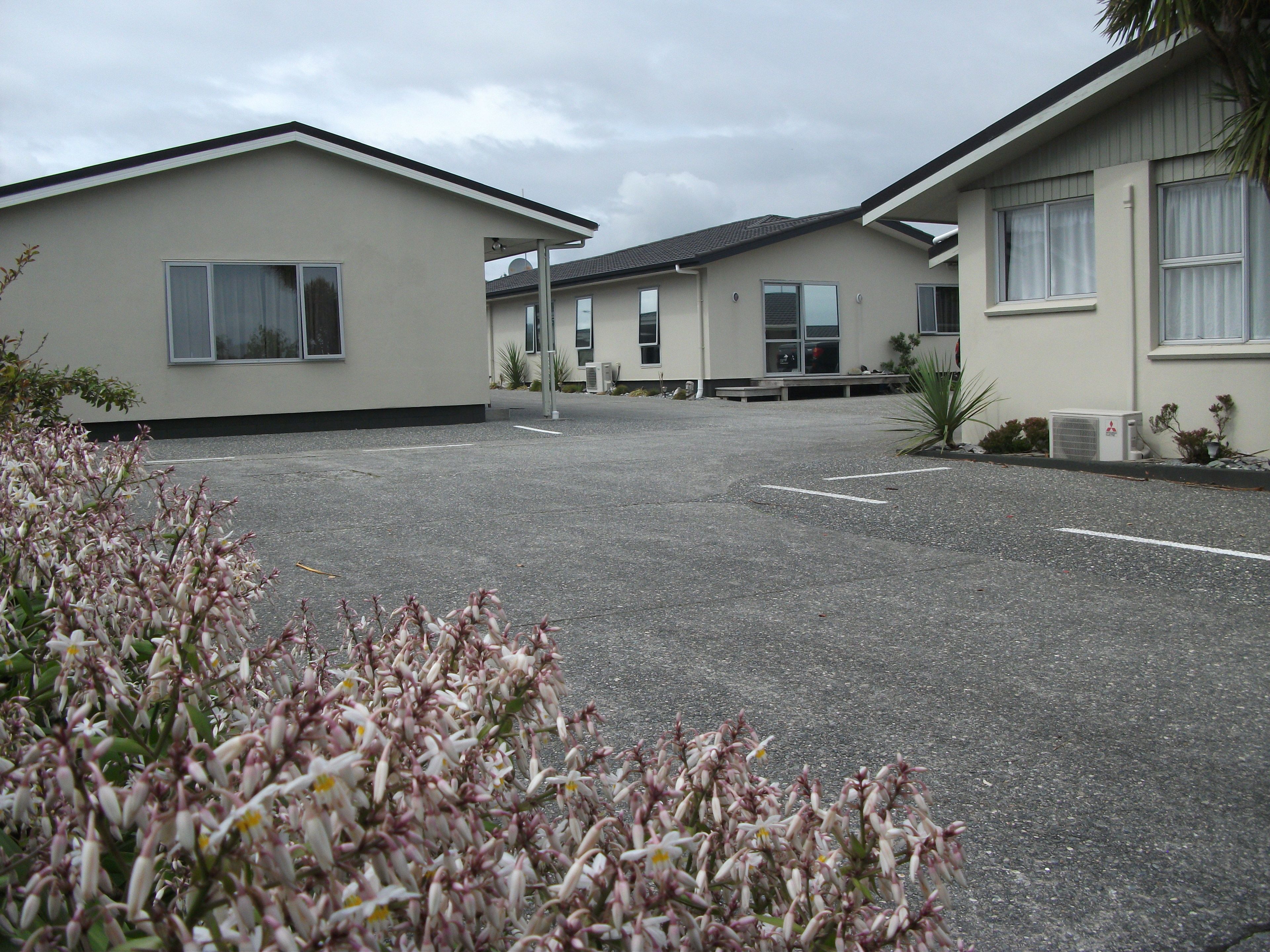 A parking lot with buildings in the background.