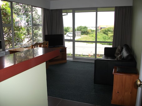 Apartment, 1 Bedroom | Living area | 32-inch flat-screen TV with satellite channels, TV