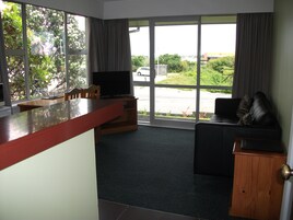 Apartment, 1 Bedroom | Living area | 32-inch flat-screen TV with satellite channels, TV