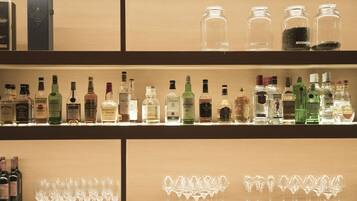 A bar area with shelves of liquor bottles and glasses.