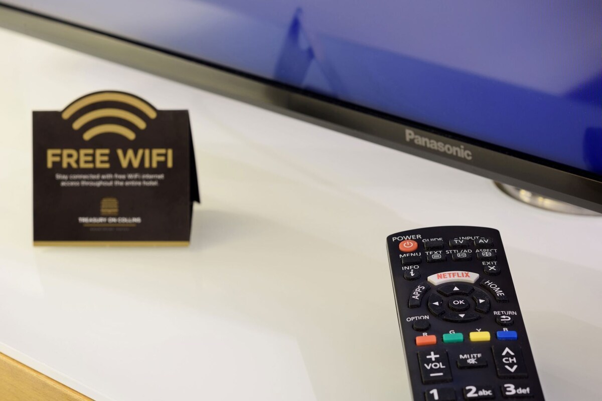 A Panasonic TV, a remote control, and a 'FREE WIFI' sign.