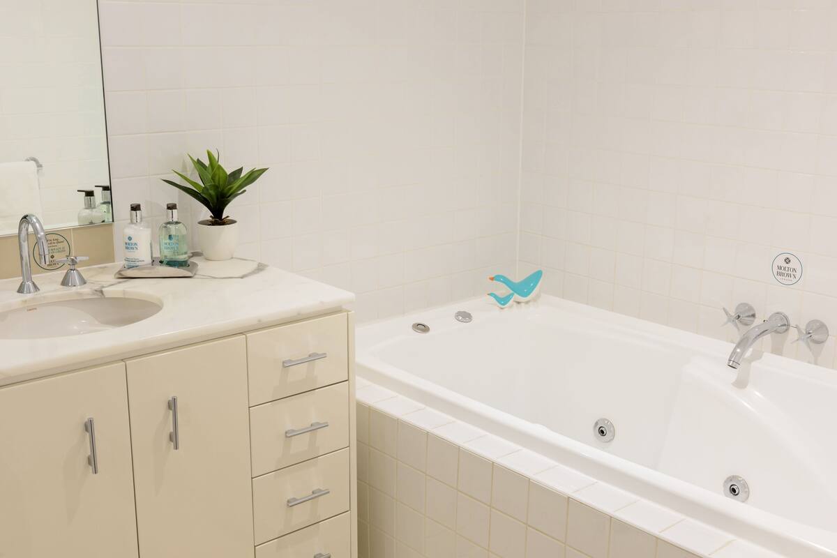 heritage loft apartment | bathroom | combined shower/bathtub, rainfall showerhead, designer toiletries