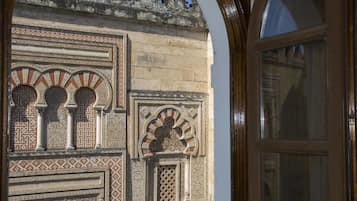 A detailed view of a building's ornate facade with intricate geometric patterns and arches.