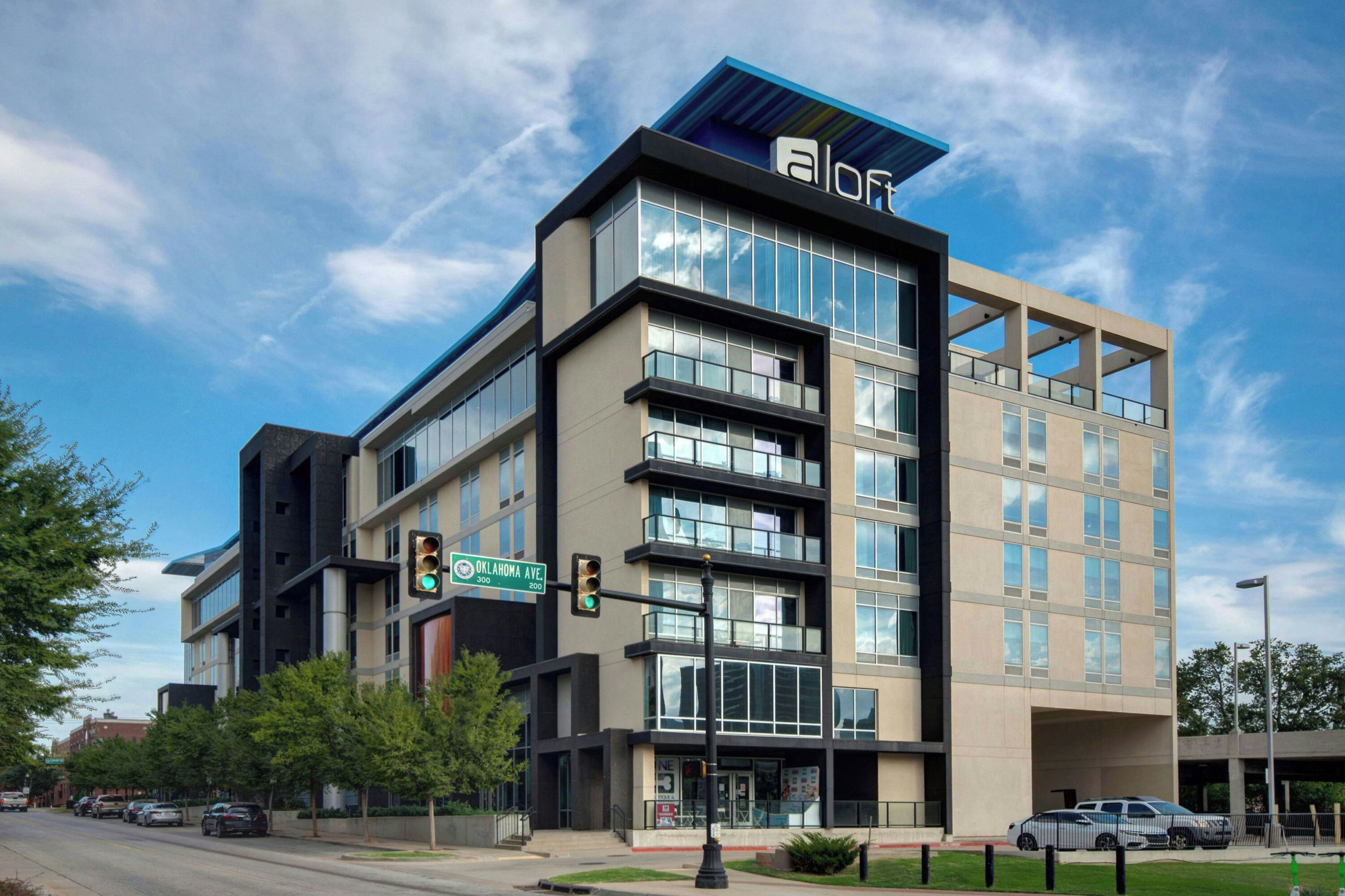 A multi-story building with a modern architectural design, featuring a prominent 'a' logo on the top.