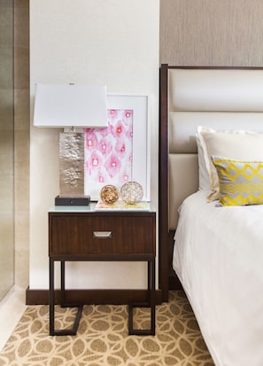 A neatly arranged hotel room with a bed, a bedside table with a lamp, a framed picture, and decorative items. - JW Marriott Houston Downtown (Houston)