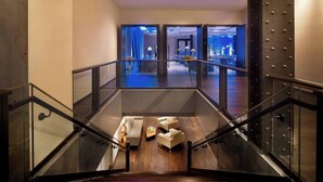 A modern interior with a staircase leading to a dining area. - JW Marriott Houston Downtown (Houston)