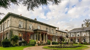 A large, historic stone building with a formal garden and a gravel driveway. - Doxford Hall Hotel & Spa (Chathill)