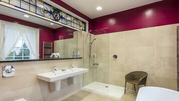 A modern bathroom with a glass shower enclosure, a white sink, and a bathtub.